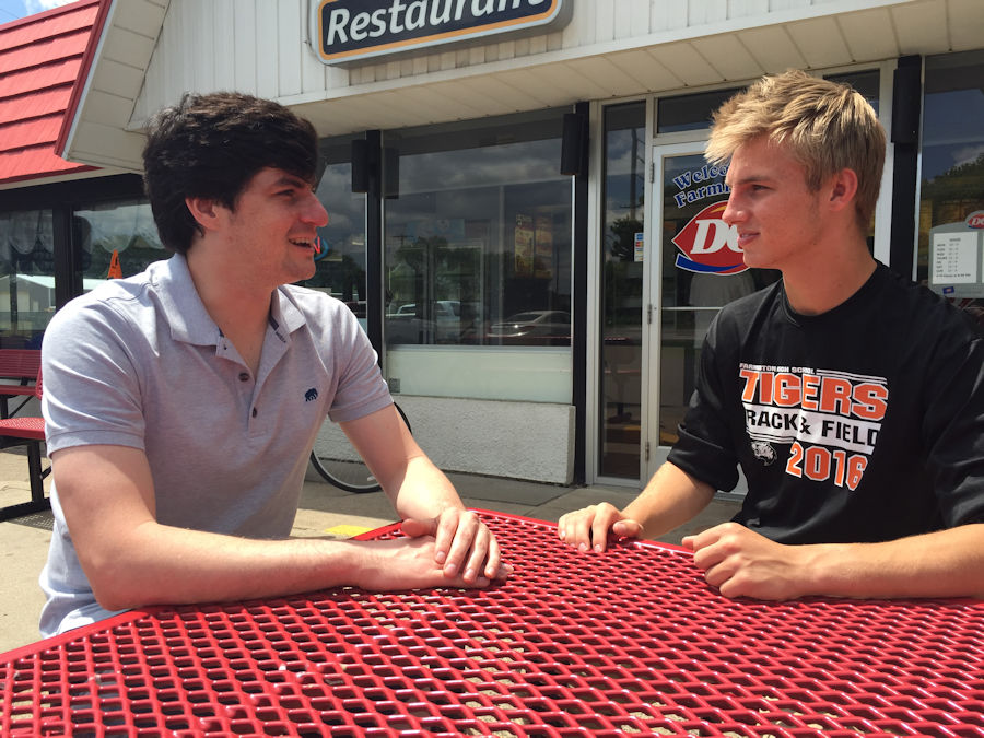 Matt talking with young man at table