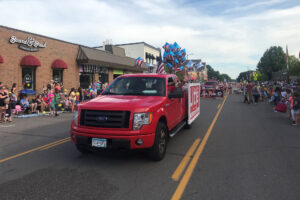 Vehicles and people at a parade