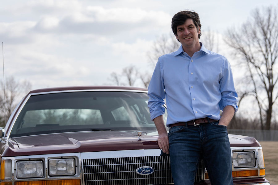 Matt standing in front of wagon with hand in pocket